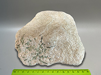 a minely crystaline white marble with green tremolite crystal formed in a radiating pattern.